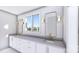Primary bathroom with double sink vanity, designer mirrors and lots of storage space at 428 Dover Ave, Charlotte, NC 28209