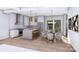 Modern kitchen features white cabinets, stainless steel appliances, an island and view to the outdoors at 428 Dover Ave, Charlotte, NC 28209