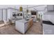 Open-concept living space with combined kitchen, dining area, and fireplace with view to the backyard at 428 Dover Ave, Charlotte, NC 28209