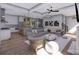 Open-concept living room with modern furnishings, adjacent to the kitchen, dining area, and staircase at 428 Dover Ave, Charlotte, NC 28209