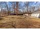 Large backyard featuring a home, trees and a storage shed at 555 Westwood Dr, Kannapolis, NC 28081