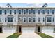 Three-unit townhome building with gray siding, brick accents, and two-car garages at 7112 Brookview Ln, Sherrills Ford, NC 28673