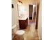 Bathroom showcasing vanity, mirror, and an open doorway to hallway at 13112 Appolinaire Dr, Davidson, NC 28036
