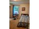 Cozy bedroom featuring a single bed, piano, window with natural light, and simple decor at 13112 Appolinaire Dr, Davidson, NC 28036