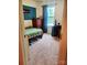 Well-lit bedroom boasts a decorative accent wall, dresser, desk, and neutral carpet at 13112 Appolinaire Dr, Davidson, NC 28036