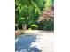 Community entrance with stone signage surrounded by mature trees and manicured landscaping at 13112 Appolinaire Dr, Davidson, NC 28036