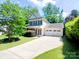 Charming two-story home featuring a two-car garage and a well-manicured lawn with mature trees at 13112 Appolinaire Dr, Davidson, NC 28036