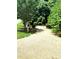 Scenic walking path amidst lush greenery and benches, offering a tranquil space for relaxation and reflection at 13112 Appolinaire Dr, Davidson, NC 28036