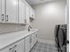 Clean laundry room with white cabinets and patterned floor at 15126 Sustar Farm Dr # 36, Matthews, NC 28105