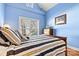 Blue bedroom with wood flooring and striped bedding at 20109 Norman Colony Rd, Cornelius, NC 28031