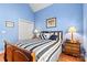 Blue bedroom with wood flooring and striped bedding at 20109 Norman Colony Rd, Cornelius, NC 28031