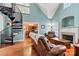Spacious living room with hardwood floors, fireplace, and spiral staircase at 20109 Norman Colony Rd, Cornelius, NC 28031