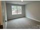 Spacious bedroom with large window and neutral walls at 403 Imperial Way # 24, Albemarle, NC 28001