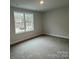 Bright bedroom with carpeted floors and a large window at 403 Imperial Way # 24, Albemarle, NC 28001