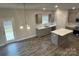 Eat-in kitchen with gray cabinets, island, and hardwood floors at 403 Imperial Way # 24, Albemarle, NC 28001