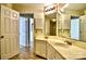 Bathroom with a double vanity, tile floor, and a framed mirror at 6125 Gray Gate Ln # F, Charlotte, NC 28210