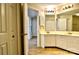 Double vanity bathroom with white cabinets and a view to the living quarters at 6125 Gray Gate Ln # F, Charlotte, NC 28210