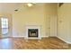 Living room with fireplace, laminate floors, and access to deck at 6125 Gray Gate Ln # F, Charlotte, NC 28210