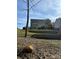 View of backyard with multilevel terraced beds, iron fence, and mature trees at 7520 Berkeley W Rd, Denver, NC 28037
