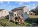 Backyard view with deck, playset, privacy fence and mature trees offering shade at 7520 Berkeley W Rd, Denver, NC 28037