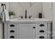 Modern bathroom vanity with white countertop, sleek black faucet, and stylish cabinet storage at 7520 Berkeley W Rd, Denver, NC 28037