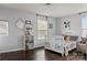 Charming bedroom with white crib and hardwood floors at 7520 Berkeley W Rd, Denver, NC 28037