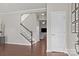 Welcoming entryway with hardwood floors, a staircase, and a view into the living room at 7520 Berkeley W Rd, Denver, NC 28037