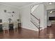 Entryway featuring hardwood floors, staircase, and a functional desk setup, blending style and utility at 7520 Berkeley W Rd, Denver, NC 28037