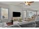 Open living room layout with hardwood floors, large TV, and seamless flow into the kitchen area at 7520 Berkeley W Rd, Denver, NC 28037