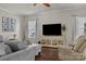 Cozy living room features a large TV, comfortable seating, and ample natural light at 7520 Berkeley W Rd, Denver, NC 28037