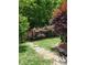 Charming backyard garden with stone pathway and lush greenery at 1035 Crescent Moon Dr, Fort Mill, SC 29715