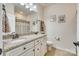 Bathroom featuring a double vanity with granite countertop, white cabinets, and a large mirror for added convenience at 1035 Crescent Moon Dr, Fort Mill, SC 29715