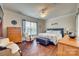 Primary bedroom featuring hardwood floors, ceiling fan, and rocking chair at 1035 Crescent Moon Dr, Fort Mill, SC 29715