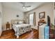 Bright bedroom featuring a bed with decorative pillows, hardwood floors, and a ceiling fan at 1035 Crescent Moon Dr, Fort Mill, SC 29715