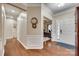 Inviting foyer with hardwood floors, white trim, front door, and wall decor adds charm to this home at 1035 Crescent Moon Dr, Fort Mill, SC 29715