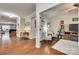 Hallway with hardwood floors leads to a living room with a fireplace and comfortable seating arrangements at 1035 Crescent Moon Dr, Fort Mill, SC 29715