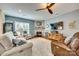 Cozy living room with a stone fireplace, plush seating, and a large window at 1035 Crescent Moon Dr, Fort Mill, SC 29715