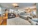 Open concept living room with hardwood floors, comfortable couches, and seamless flow to kitchen at 1035 Crescent Moon Dr, Fort Mill, SC 29715