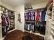 Walk-in closet with custom shelving, clothes racks, and hardwood floors at 1035 Crescent Moon Dr, Fort Mill, SC 29715