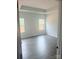 Spacious bedroom with grey vinyl flooring and multiple windows at 1054 Bull Dog Ln, Wingate, NC 28174
