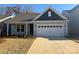 Two-toned exterior of charming new home with attached garage at 1054 Bull Dog Ln, Wingate, NC 28174