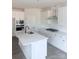 Modern kitchen featuring white cabinets, island, and stainless steel appliances at 1054 Bull Dog Ln, Wingate, NC 28174