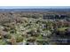 Aerial view showcasing the home's location within a neighborhood, surrounded by mature trees and winding streets at 2216 Lowell Bethesda Rd, Gastonia, NC 28056