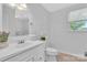 Bathroom featuring a white vanity, decorative plants, window, and updated finishes at 2216 Lowell Bethesda Rd, Gastonia, NC 28056