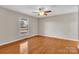 An airy bedroom with hardwood floors, a ceiling fan, and natural light, offering a comfortable space to relax at 2216 Lowell Bethesda Rd, Gastonia, NC 28056