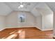 Cozy bedroom featuring hardwood floors, neutral walls, natural light and angled ceilings at 2216 Lowell Bethesda Rd, Gastonia, NC 28056