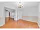 Bright dining room featuring light paint, chair rail, light fixture, and open entryway to living room at 2216 Lowell Bethesda Rd, Gastonia, NC 28056