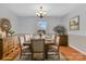 Elegant dining room featuring a large table set for a meal, buffet cabinets, and a view of the yard at 2216 Lowell Bethesda Rd, Gastonia, NC 28056