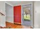 Bright foyer features hardwood floors, and a striking red front door leading to a covered porch at 2216 Lowell Bethesda Rd, Gastonia, NC 28056