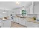 Bright kitchen featuring white cabinets, modern appliances, and stylish countertops, perfect for culinary enthusiasts at 2216 Lowell Bethesda Rd, Gastonia, NC 28056